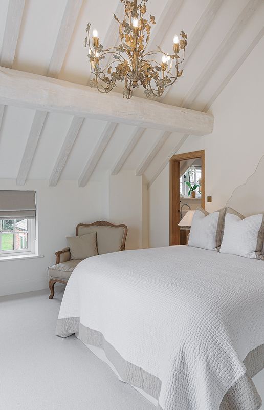 A bedroom with painted beams
