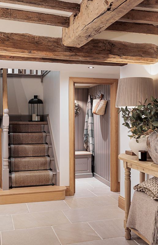 A flagstone hallway with oak staircase