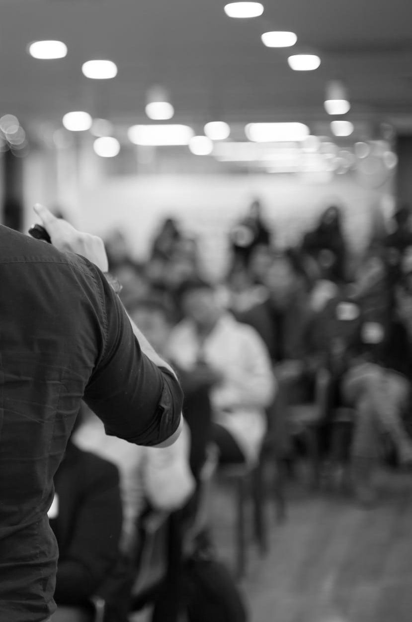 An auctioneer addressing a room of bidders
