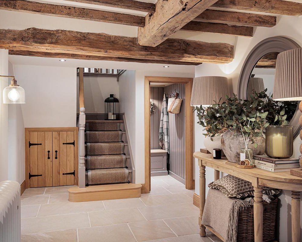 A flagstone hallway with oak staircase