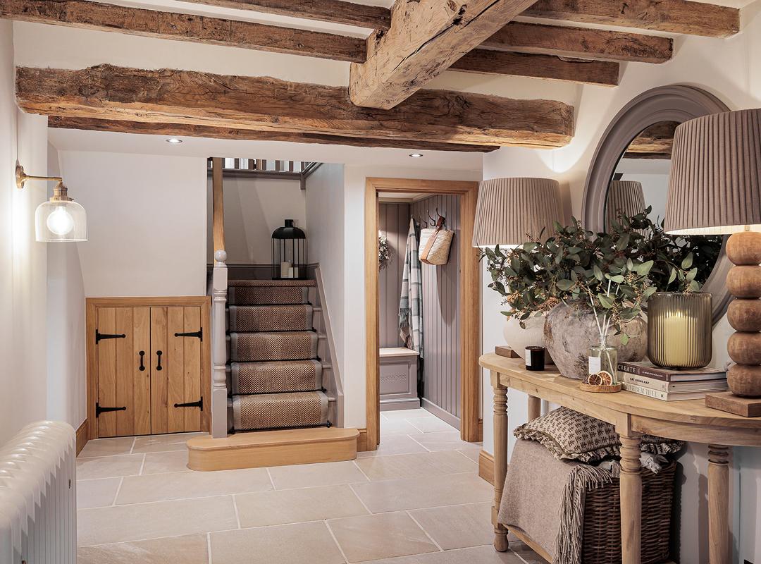 A flagstone hallway with oak staircase